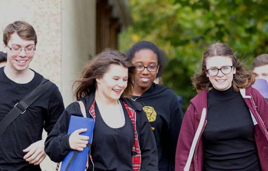 Students smiling and walking together in a group