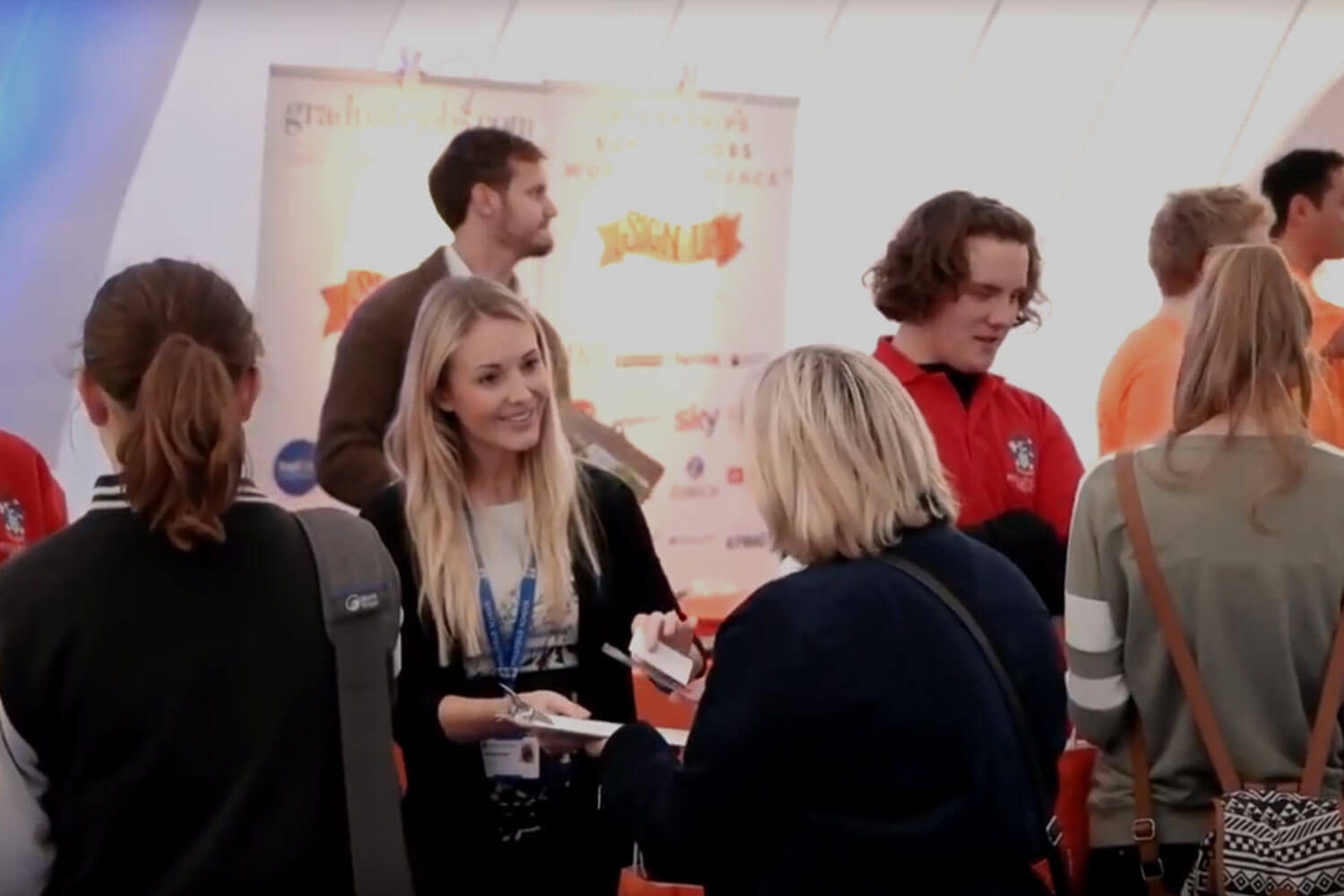 Woman hands business card to someone