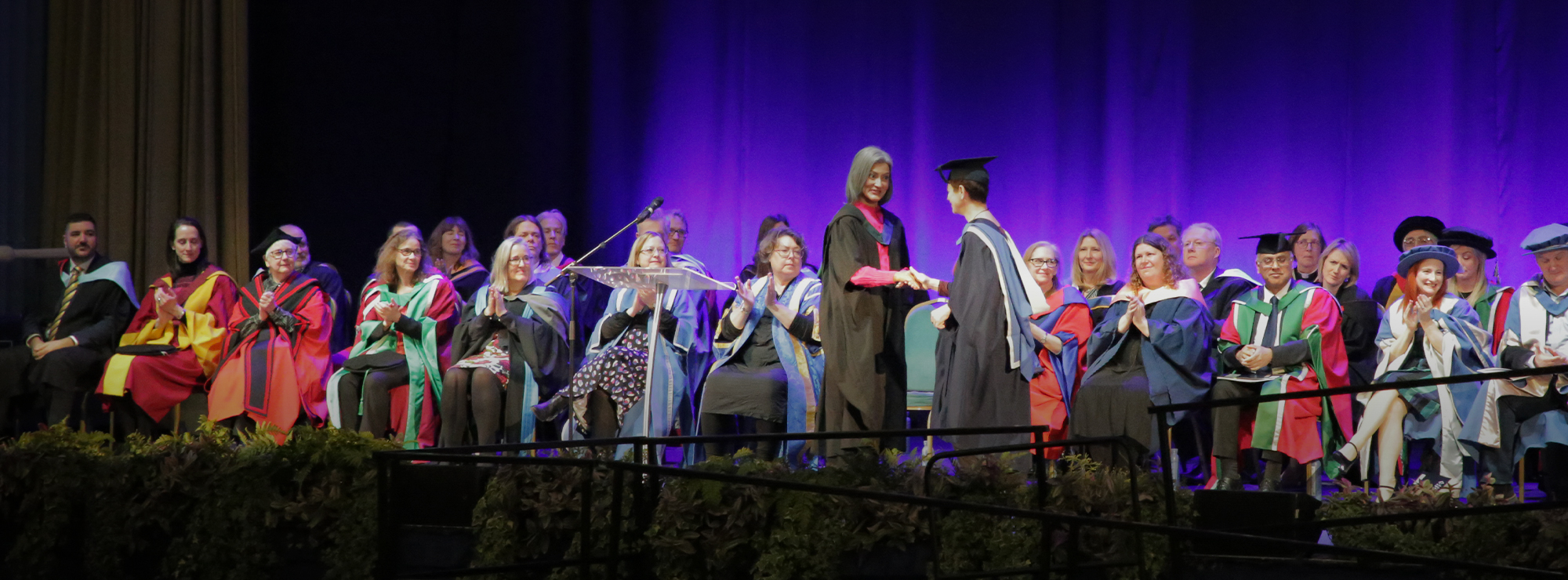 Chancellor, Sharanjit Leyl congratulates a student at Graduation