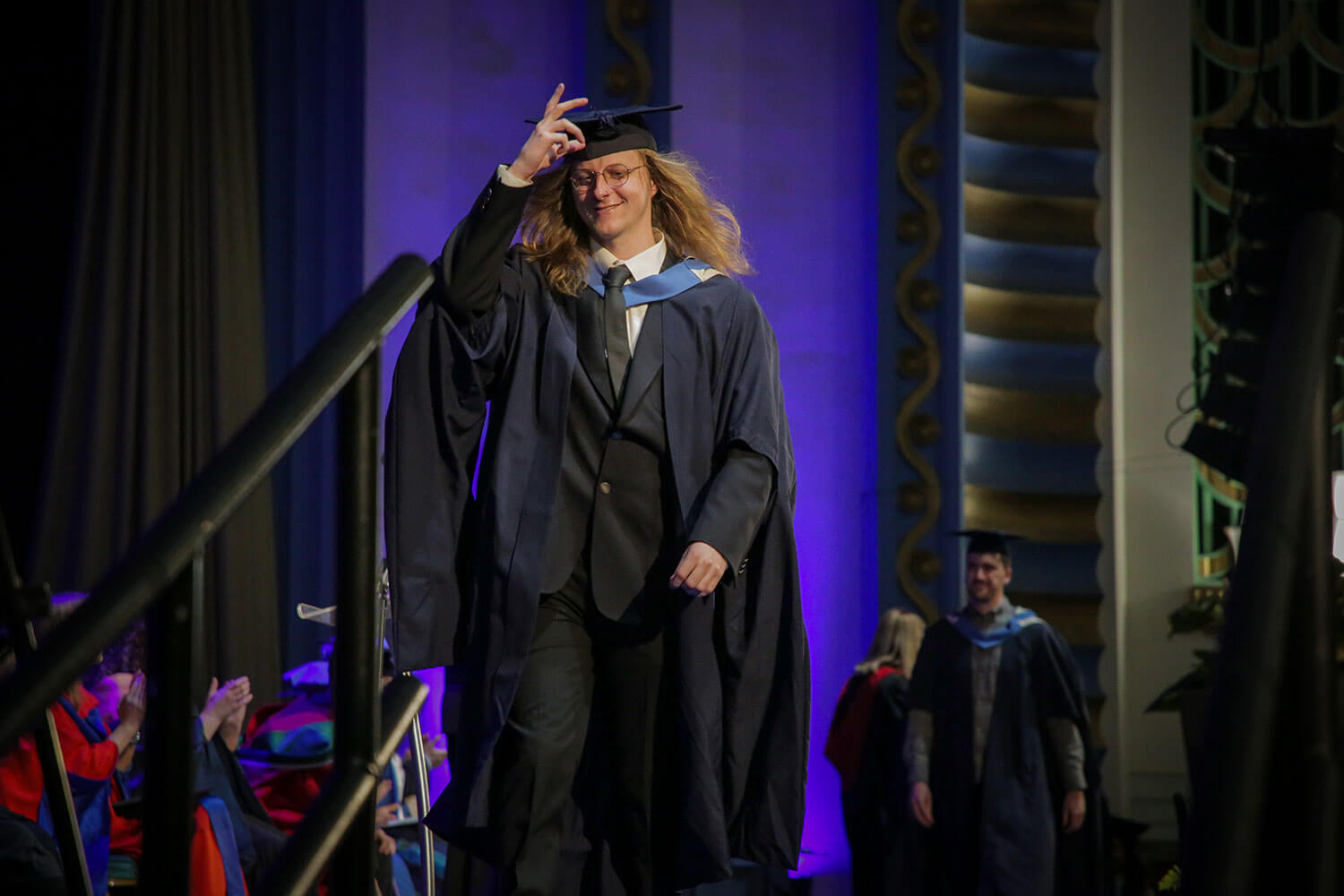 Graduand tips his mortar board hat