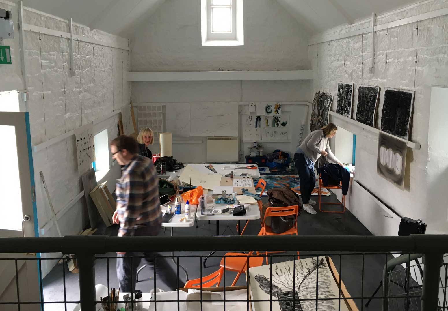 Artists mill around their designated studio