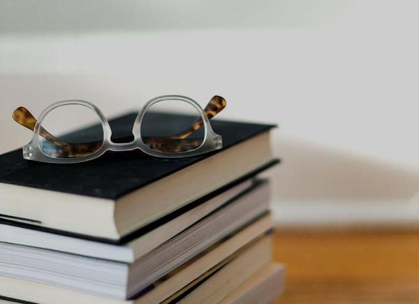 Stack of books with a pair of glasses on top2