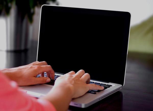 Person typing at laptop