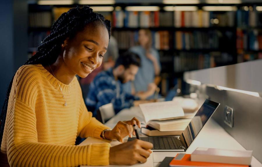 Student using a laptop in a library