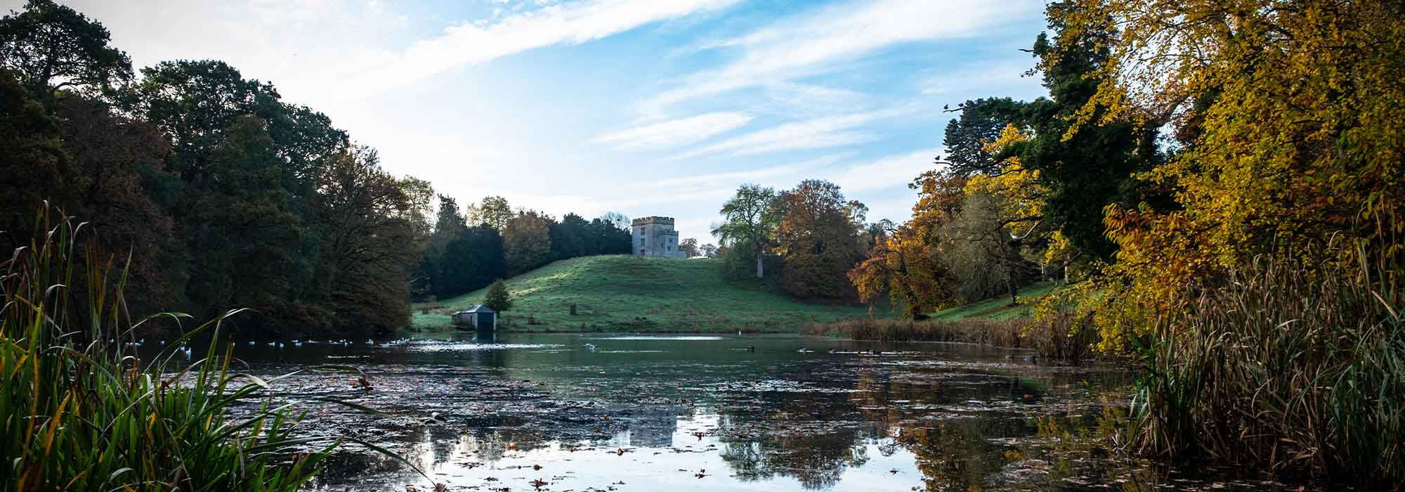 View across lake towards castle on clear autumn day