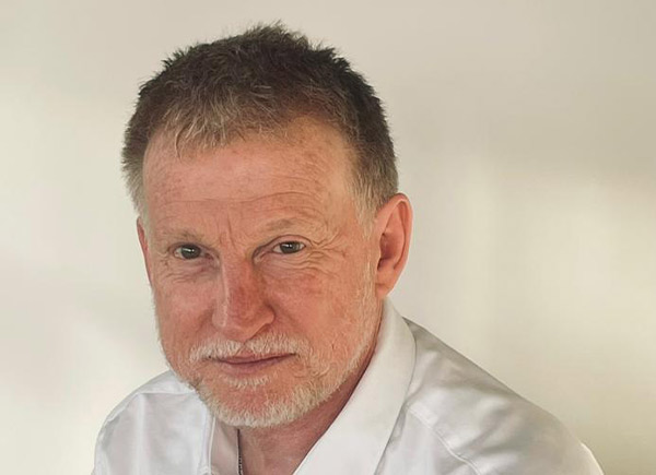 Person wearing white shirt smiling at camera