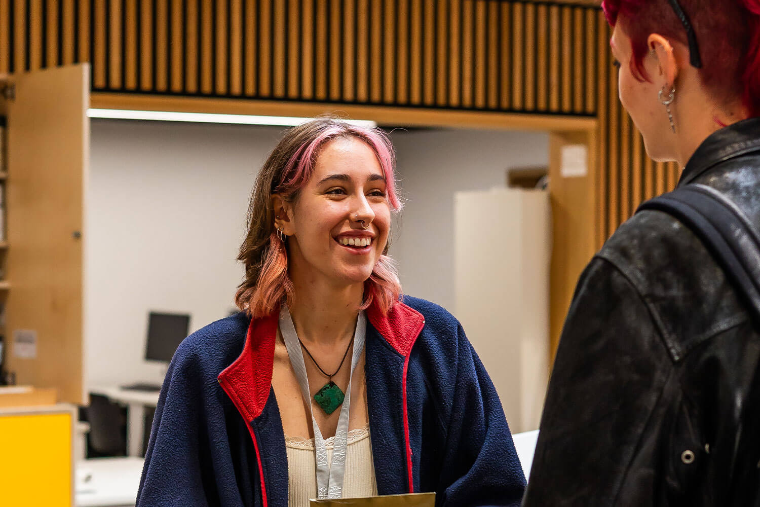 Smiling student chats to a friend at Locksbrook Campus