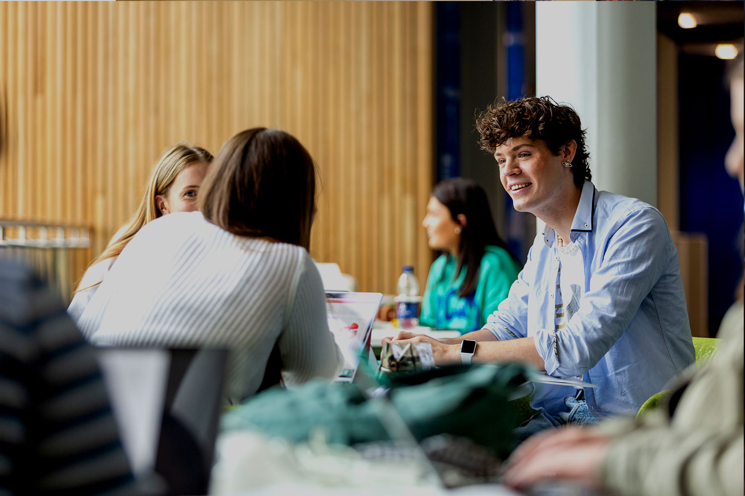 A smiling group of students study together