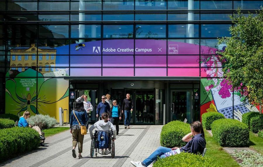 Image of group of young people moving towards Commons building Newton Park